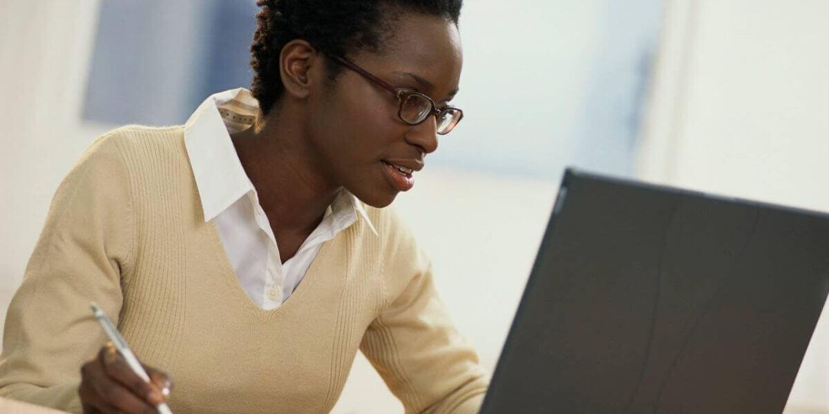 Photo of a usiu online student studying on a tablet in a café