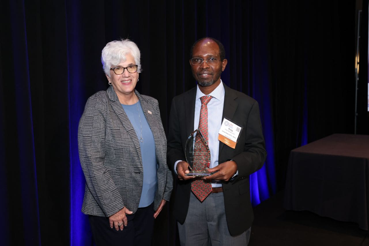Dr Phillip Machoka with the award for Outstanding Impact by a Non US Higher Education Organization from QM